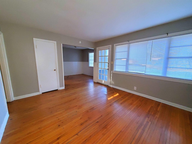 empty room with hardwood / wood-style floors