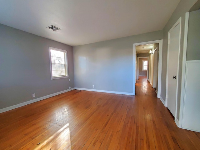 spare room featuring hardwood / wood-style floors and a wealth of natural light