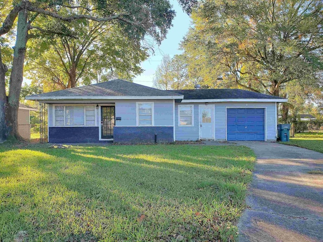 ranch-style house featuring a garage and a front yard