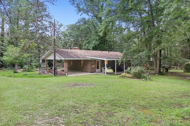 rear view of house featuring a lawn