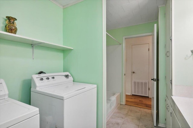 clothes washing area featuring washer and clothes dryer