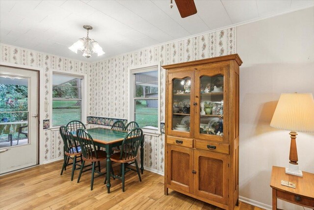 dining area featuring ceiling fan with notable chandelier, crown molding, and light hardwood / wood-style flooring