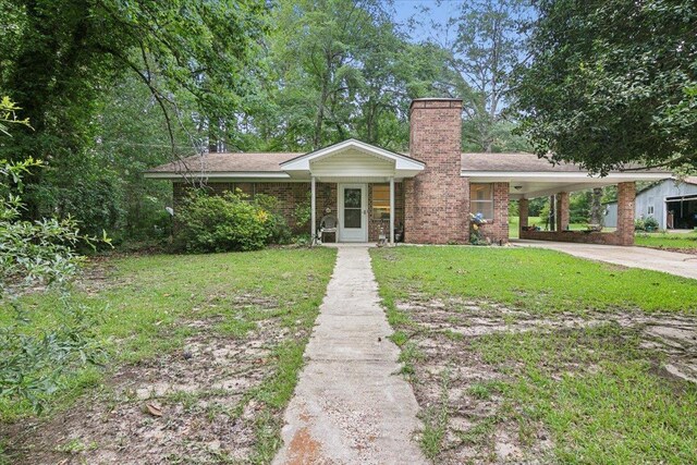 ranch-style house featuring a front lawn and a carport