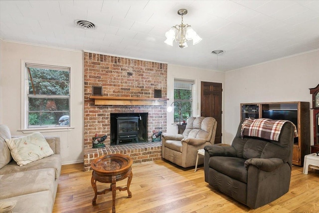 living room featuring a chandelier, a healthy amount of sunlight, and light hardwood / wood-style floors