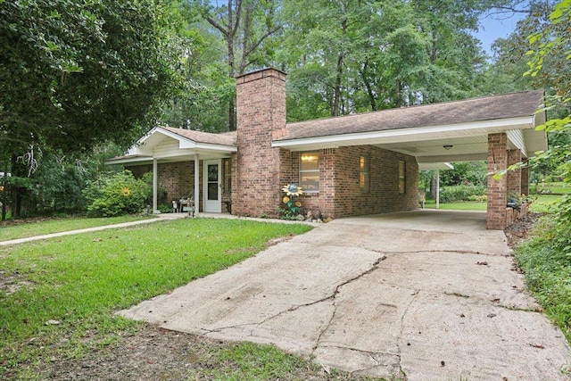 ranch-style home featuring a carport and a front yard