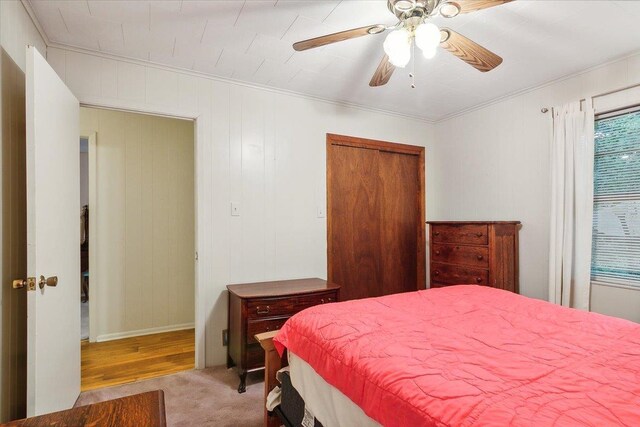 carpeted bedroom featuring ceiling fan and a closet