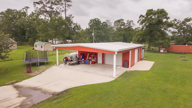1100 Mitzi Rd, Vidor, TX 77662 - garage featuring a trampoline, a detached garage, and concrete driveway