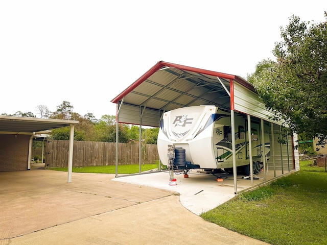1100 Mitzi Rd, Vidor, TX 77662 - view of vehicle parking with a detached carport and concrete driveway