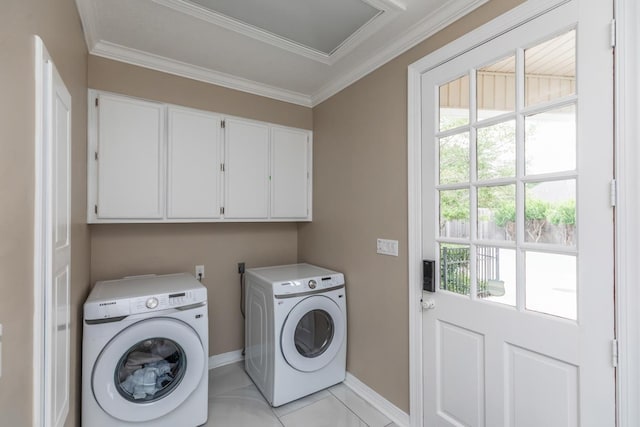 laundry area featuring cabinet space, baseboards, ornamental molding, and washer and clothes dryer