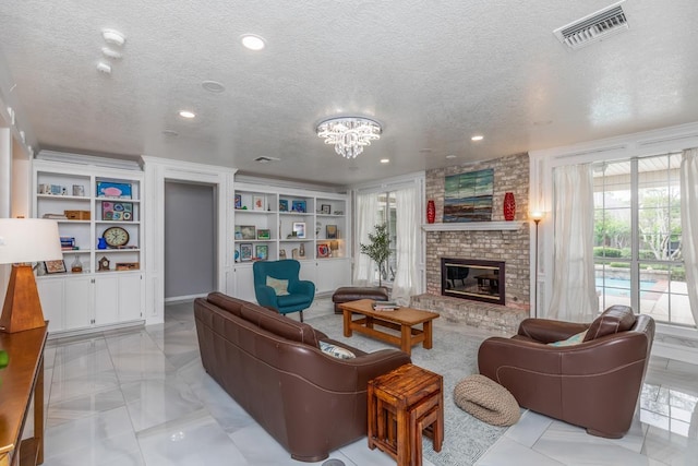 living room featuring a brick fireplace, a textured ceiling, visible vents, and a healthy amount of sunlight