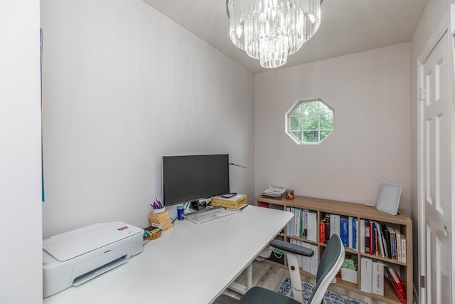 home office with a notable chandelier and wood finished floors