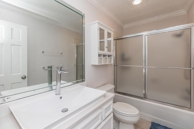 bathroom with crown molding, toilet, shower / bath combination with glass door, and vanity