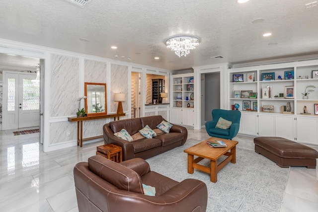 living room featuring an inviting chandelier, built in features, recessed lighting, and a textured ceiling