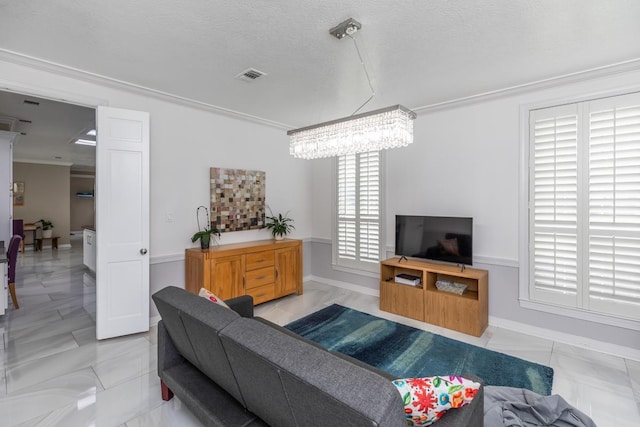 living area with crown molding, a textured ceiling, a chandelier, baseboards, and visible vents
