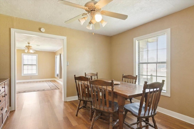 209 Boutwell Rd, Beaumont, TX 77713 - dining area featuring wood finished floors, a ceiling fan, a textured ceiling, and baseboards