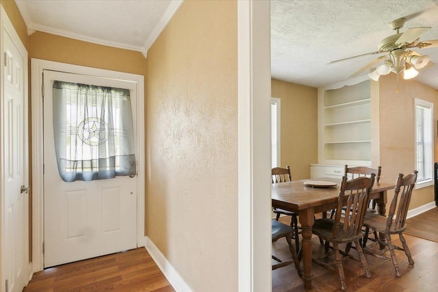 209 Boutwell Rd, Beaumont, TX 77713 - dining room with ceiling fan, wood finished floors, ornamental molding, baseboards, and built in features