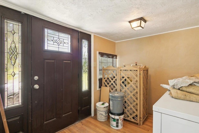 209 Boutwell Rd, Beaumont, TX 77713 - entryway featuring light wood-style floors, crown molding, and a textured ceiling