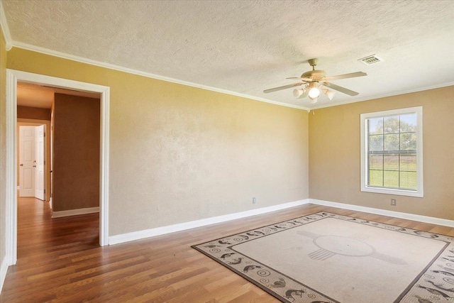 209 Boutwell Rd, Beaumont, TX 77713 - unfurnished room with wood finished floors, crown molding, a ceiling fan, baseboards, and a textured ceiling