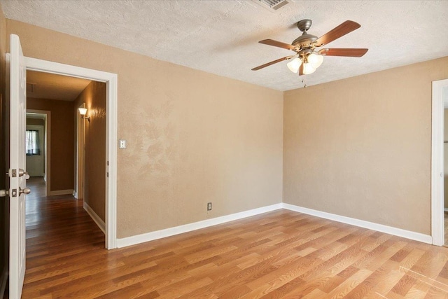 209 Boutwell Rd, Beaumont, TX 77713 - unfurnished room featuring light wood finished floors, a ceiling fan, baseboards, and a textured ceiling