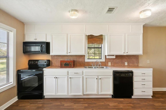 209 Boutwell Rd, Beaumont, TX 77713 - kitchen featuring black appliances, a sink, backsplash, baseboards, and a textured ceiling