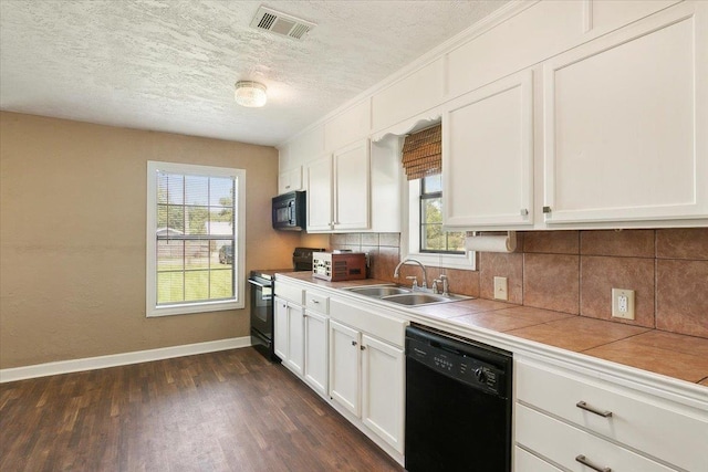 209 Boutwell Rd, Beaumont, TX 77713 - kitchen with black appliances, a sink, tile counters, a textured ceiling, and baseboards