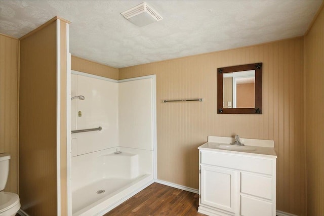 209 Boutwell Rd, Beaumont, TX 77713 - bathroom with wood finished floors, toilet, vanity, a shower, and baseboards