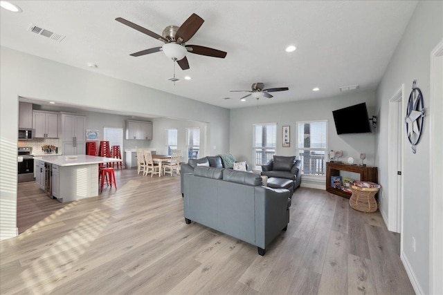 1326 Emerald Dr, Port Bolivar, TX 77650 - living area featuring a ceiling fan, light wood-type flooring, and recessed lighting