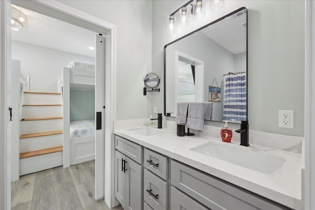 1326 Emerald Dr, Port Bolivar, TX 77650 - full bathroom featuring double vanity and wood finished floors