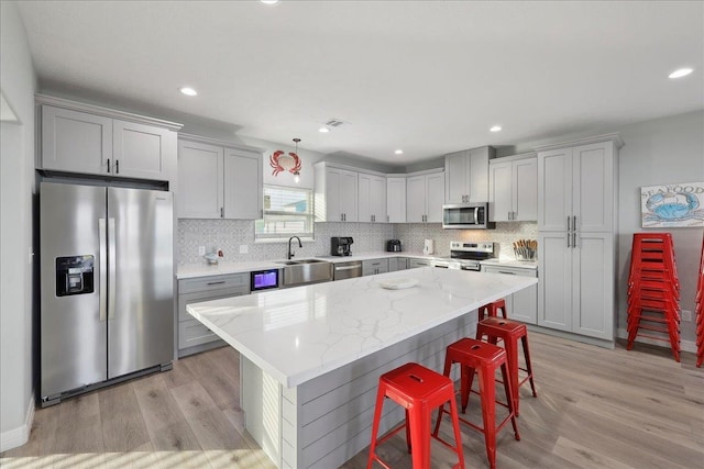 1326 Emerald Dr, Port Bolivar, TX 77650 - kitchen featuring stainless steel appliances, gray cabinets, light wood-style flooring, and recessed lighting