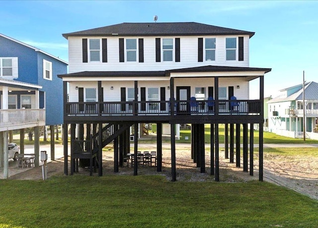 1326 Emerald Dr, Port Bolivar, TX 77650 - rear view of house featuring a yard, a wooden deck, and stairs
