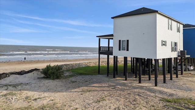 1326 Emerald Dr, Port Bolivar, TX 77650 - view of side of property featuring view of water and beach, a carport, and driveway