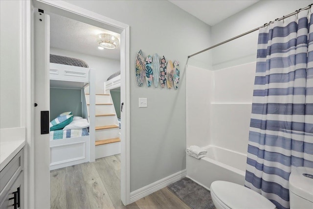 1326 Emerald Dr, Port Bolivar, TX 77650 - bathroom featuring wood finished floors, shower / tub combo with curtain, and vanity