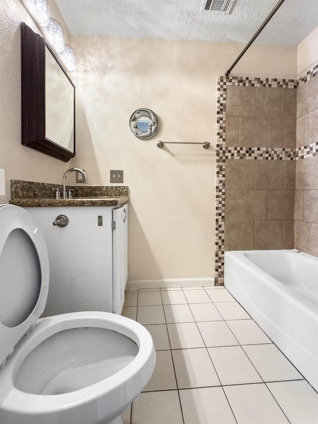 full bathroom with tile patterned flooring, a textured ceiling, toilet, vanity, and tiled shower / bath