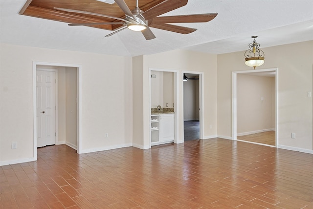 empty room with ceiling fan, wood ceiling, and sink