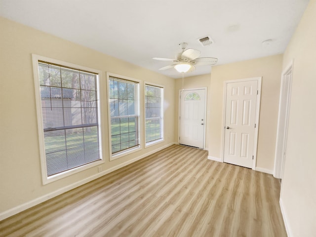 unfurnished room with ceiling fan and light wood-type flooring