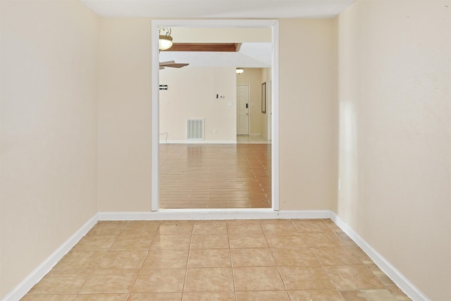 spare room featuring ceiling fan and light tile patterned flooring