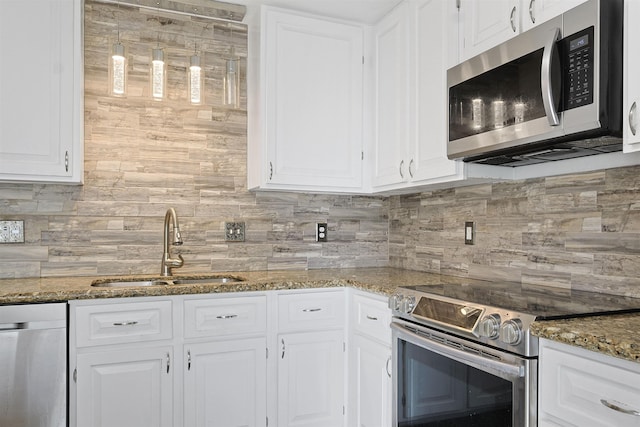 kitchen with tasteful backsplash, stainless steel appliances, sink, stone counters, and white cabinetry