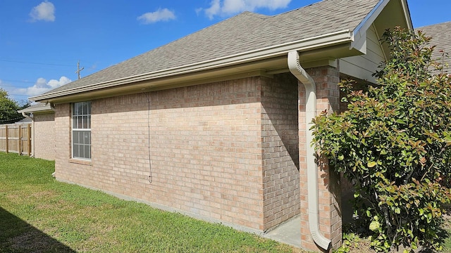 view of side of home with a lawn