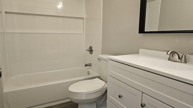 full bathroom with hardwood / wood-style flooring, vanity, shower / bathtub combination, and toilet