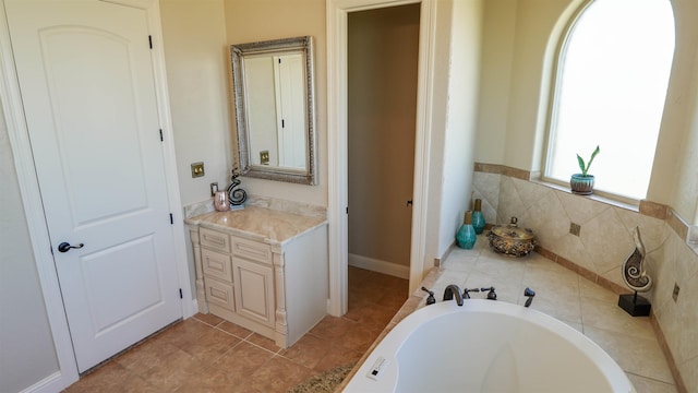 bathroom with tile patterned flooring, vanity, and a bathtub