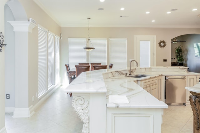 kitchen featuring dishwasher, light tile patterned floors, arched walkways, and a sink