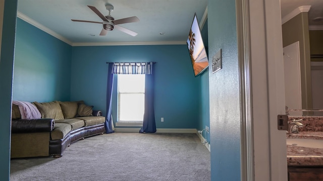 living room with a ceiling fan, baseboards, carpet, and crown molding