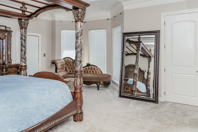 carpeted bedroom featuring crown molding and decorative columns