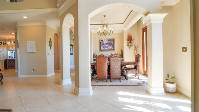 10940 Sheila Ct, Beaumont, TX 77705 - dining space featuring a chandelier, arched walkways, crown molding, light tile patterned flooring, and ornate columns