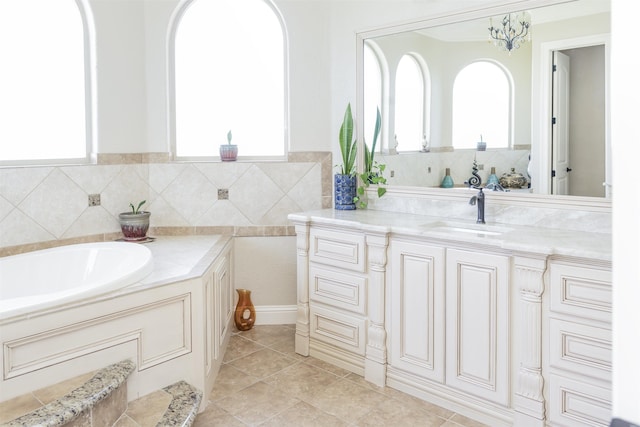 bathroom with vanity, tile patterned flooring, a wealth of natural light, and a tub