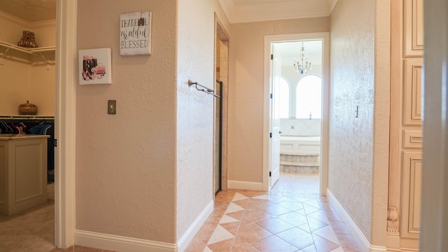 10940 Sheila Ct, Beaumont, TX 77705 - hall featuring a textured wall, ornamental molding, a chandelier, inlaid floor details, and light tile patterned floors