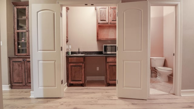 bathroom featuring vanity, toilet, and wood finished floors