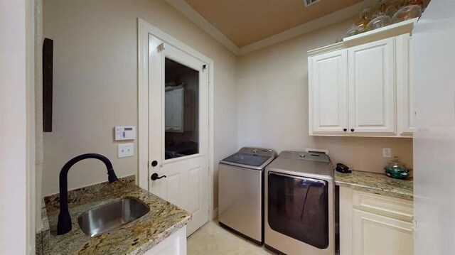10940 Sheila Ct, Beaumont, TX 77705 - laundry room featuring cabinet space, separate washer and dryer, and ornamental molding