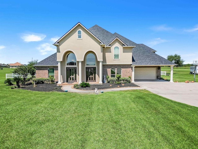 view of front of house with covered porch, a garage, and a front lawn