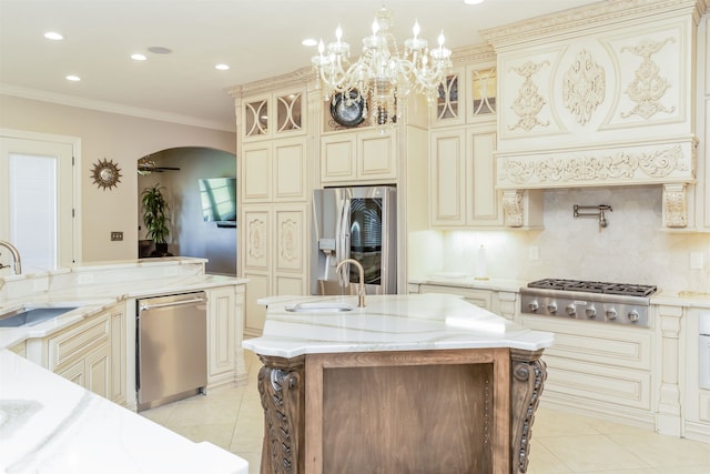 10940 Sheila Ct, Beaumont, TX 77705 - kitchen with cream cabinetry, stainless steel appliances, light tile patterned flooring, light stone countertops, and recessed lighting